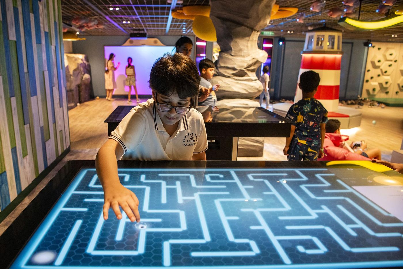 Interactive adventure play space with climbing wall