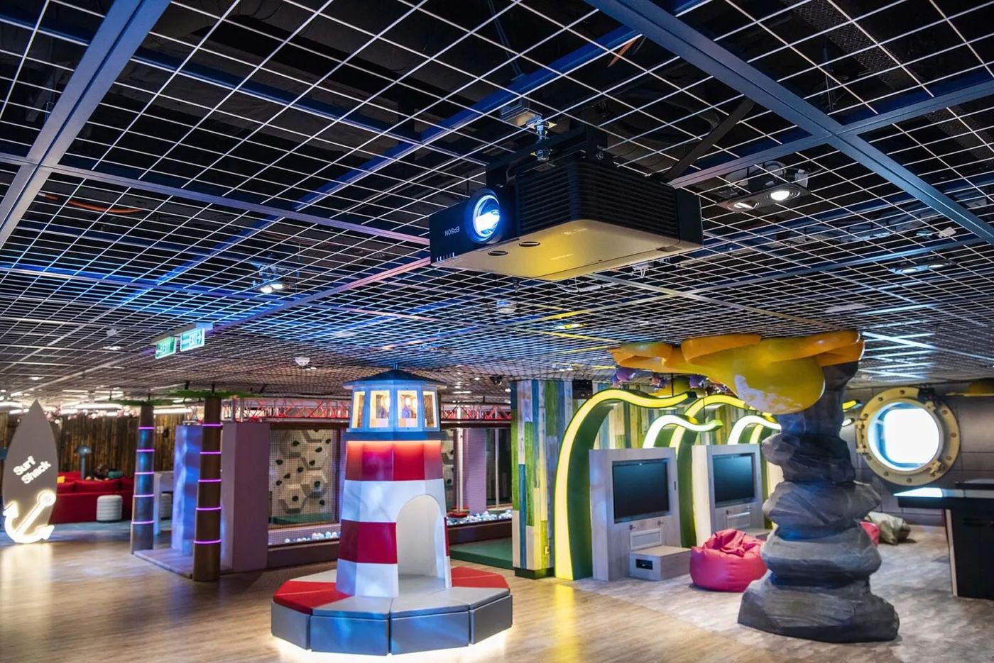 Large combination play structure with lighthouse theme in a family entertainment centre