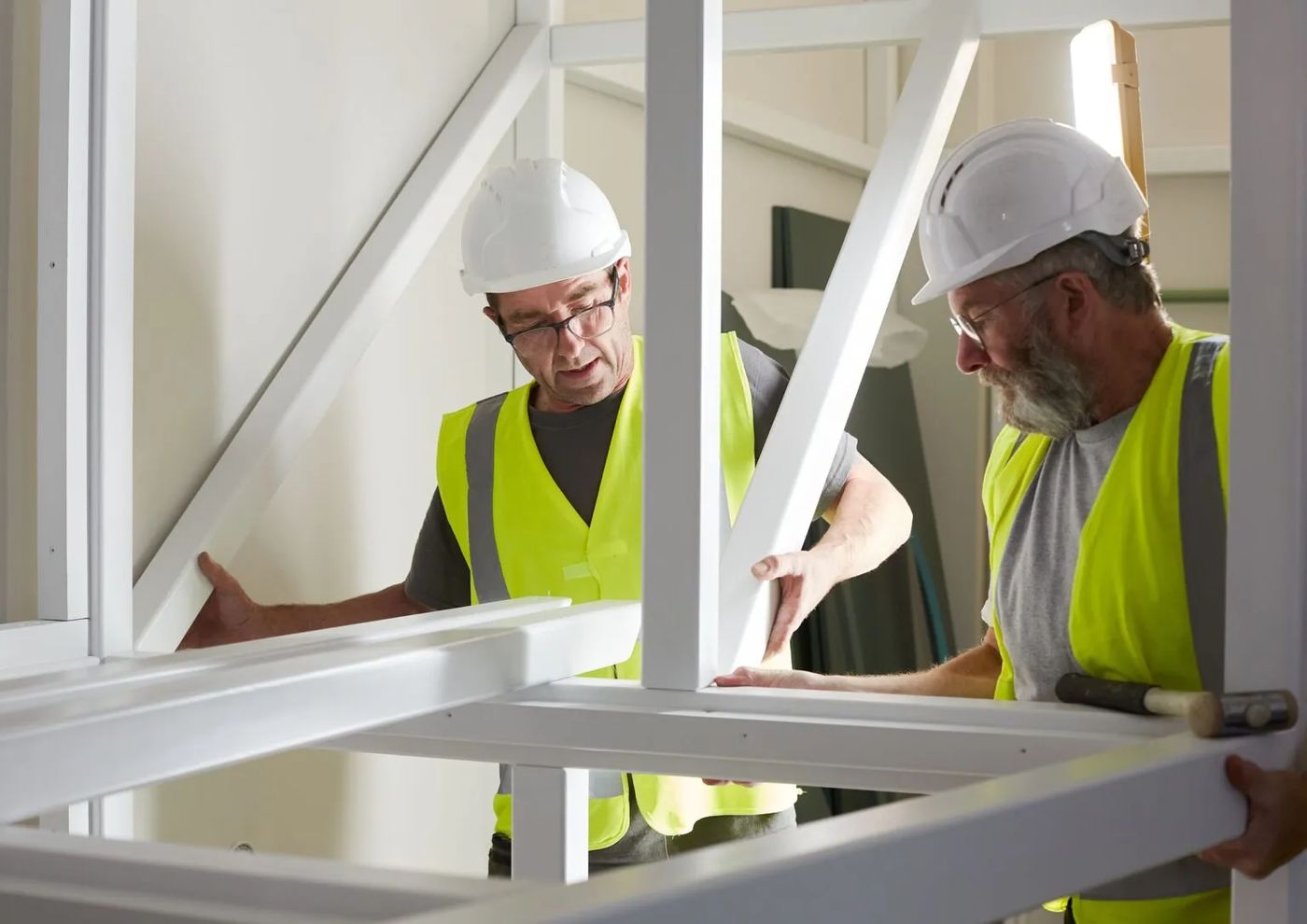 SuntonPlay installation team assembling a galvanized steel play structure frame