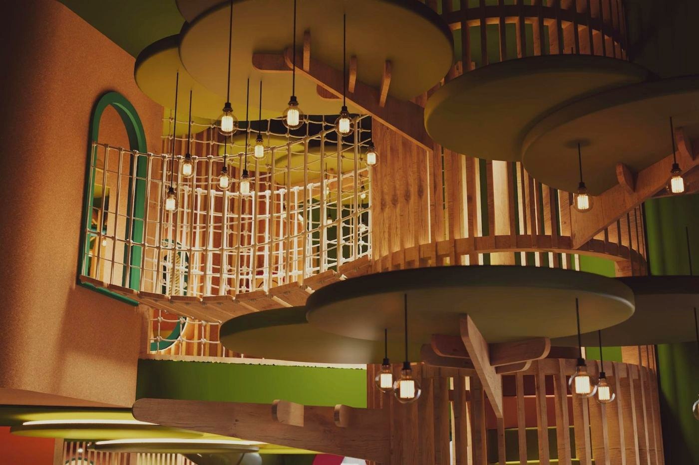 Custom wooden indoor playground with rope bridge and slides, designed and manufactured by SuntonPlay