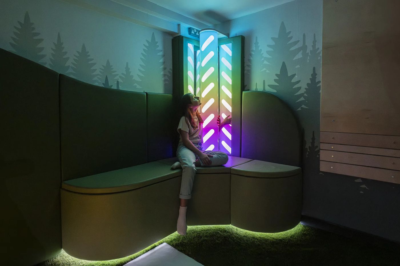 SuntonSense sensory room with interactive colour-light column and curved padded seating